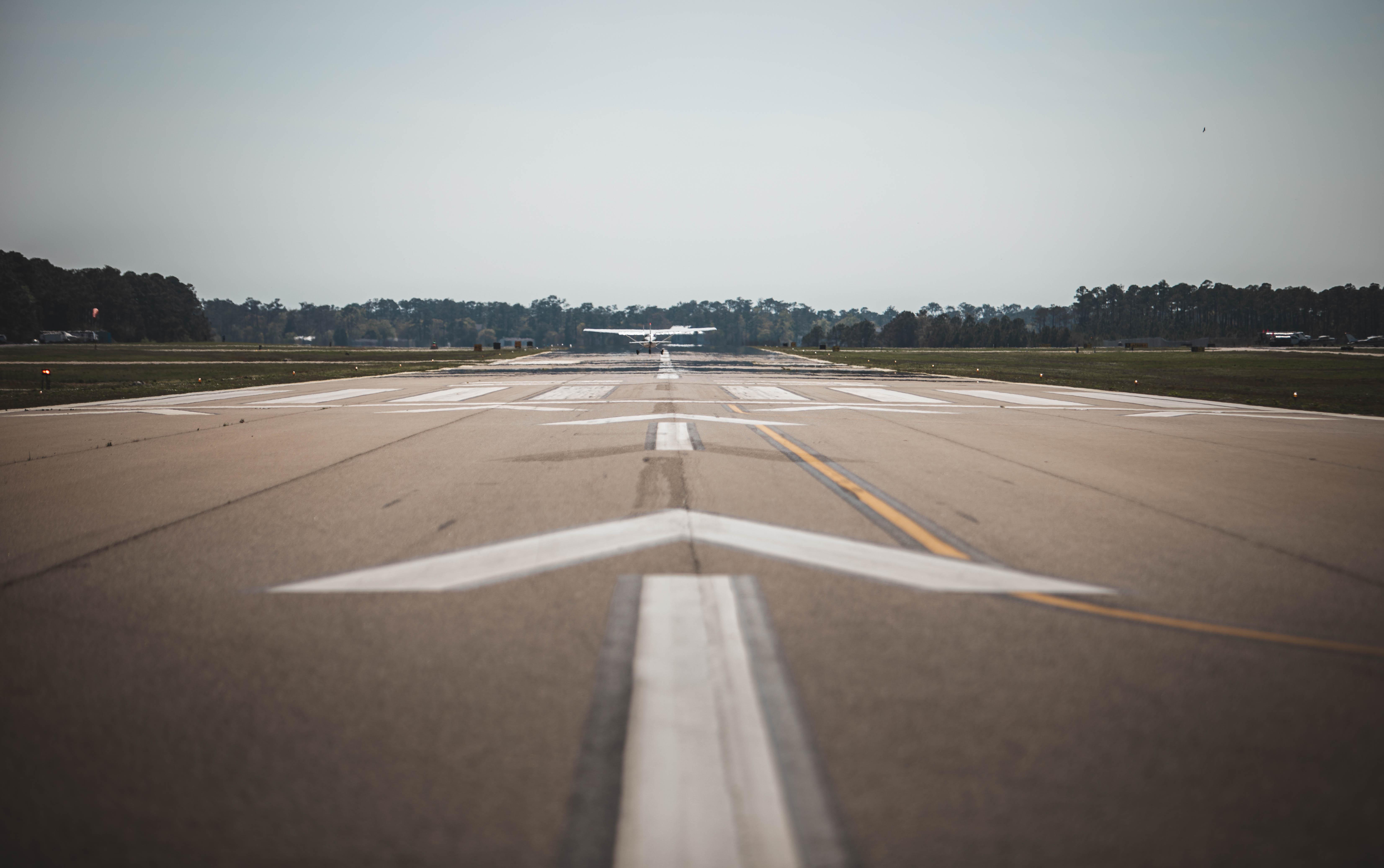 Cessna taking off at sunset from a runway at High Tide Aviation in Southport, NC.