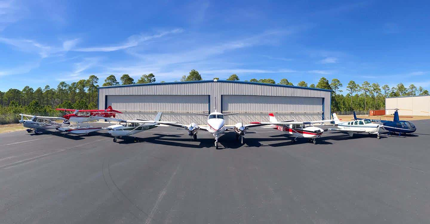 High Tide Aviation fleet of aircraft in hangar at sunset