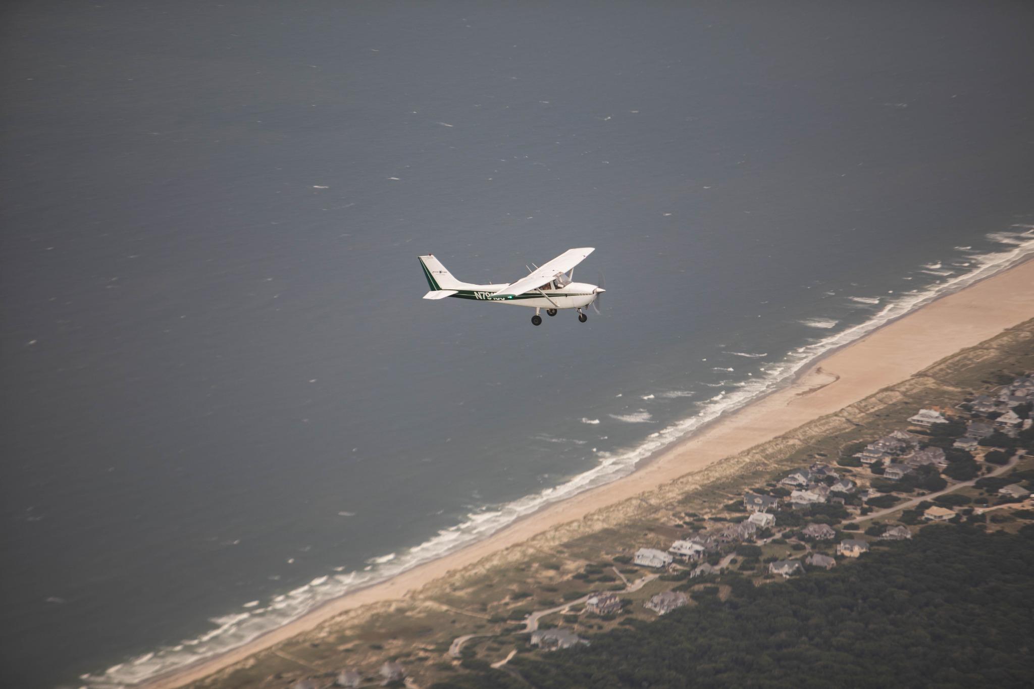 Cessna 172 over beach