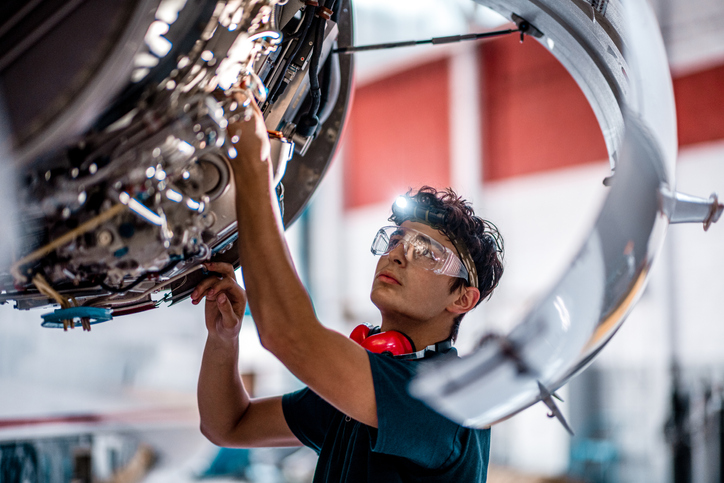 Student checking Cessna motor