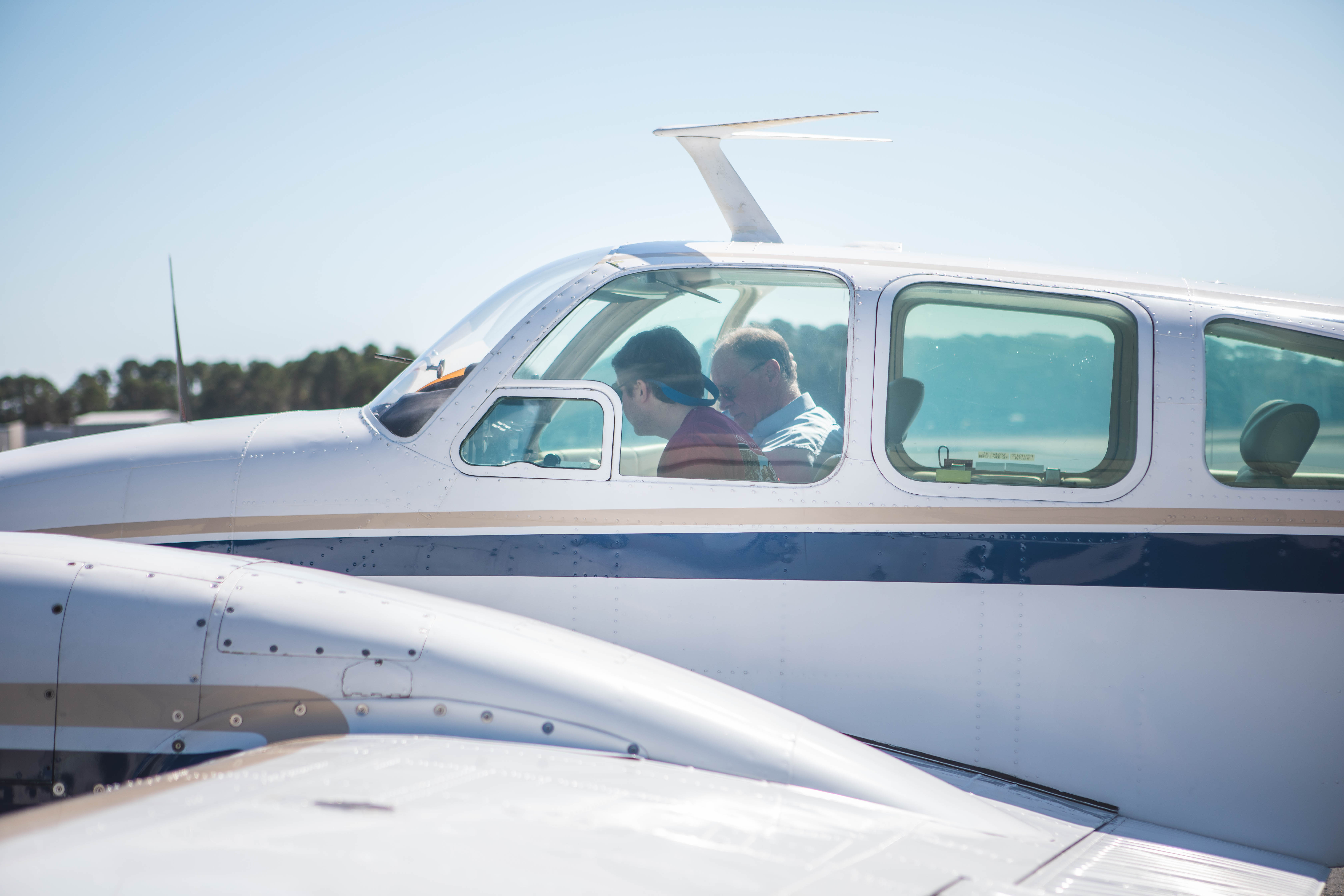 Flight instructor and student pilot seated in a Beechcraft B55 Baron cockpit