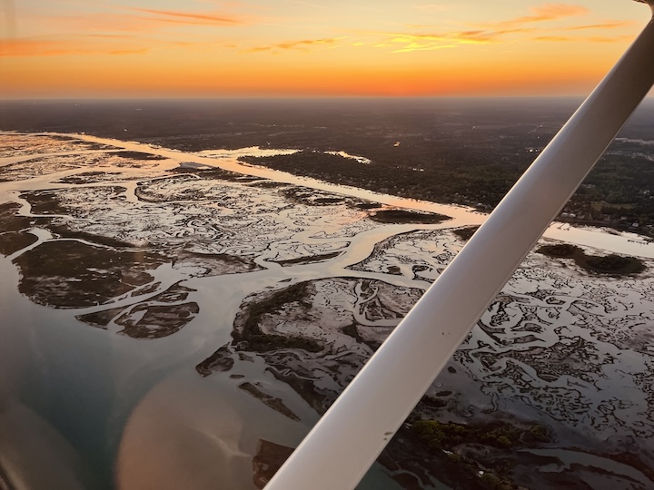 High Tide Aviation aircraft flying over the coast for coastal flight training