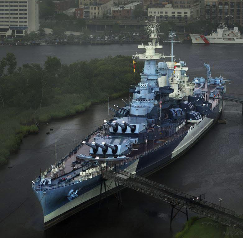 View from above of a battleship in a city river